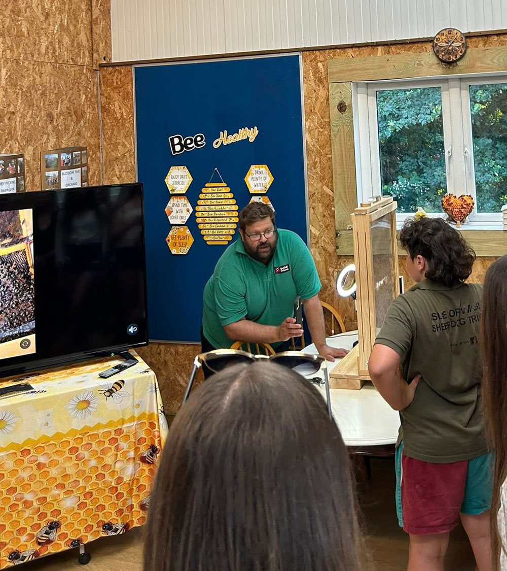 Childrem and parents learning about Bees at Godshill Orchards on the Isle of Wight